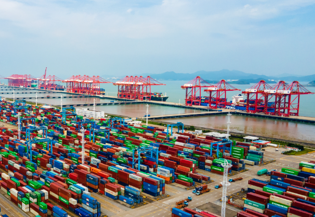 Steel plates being loaded at a Chinese port for international delivery