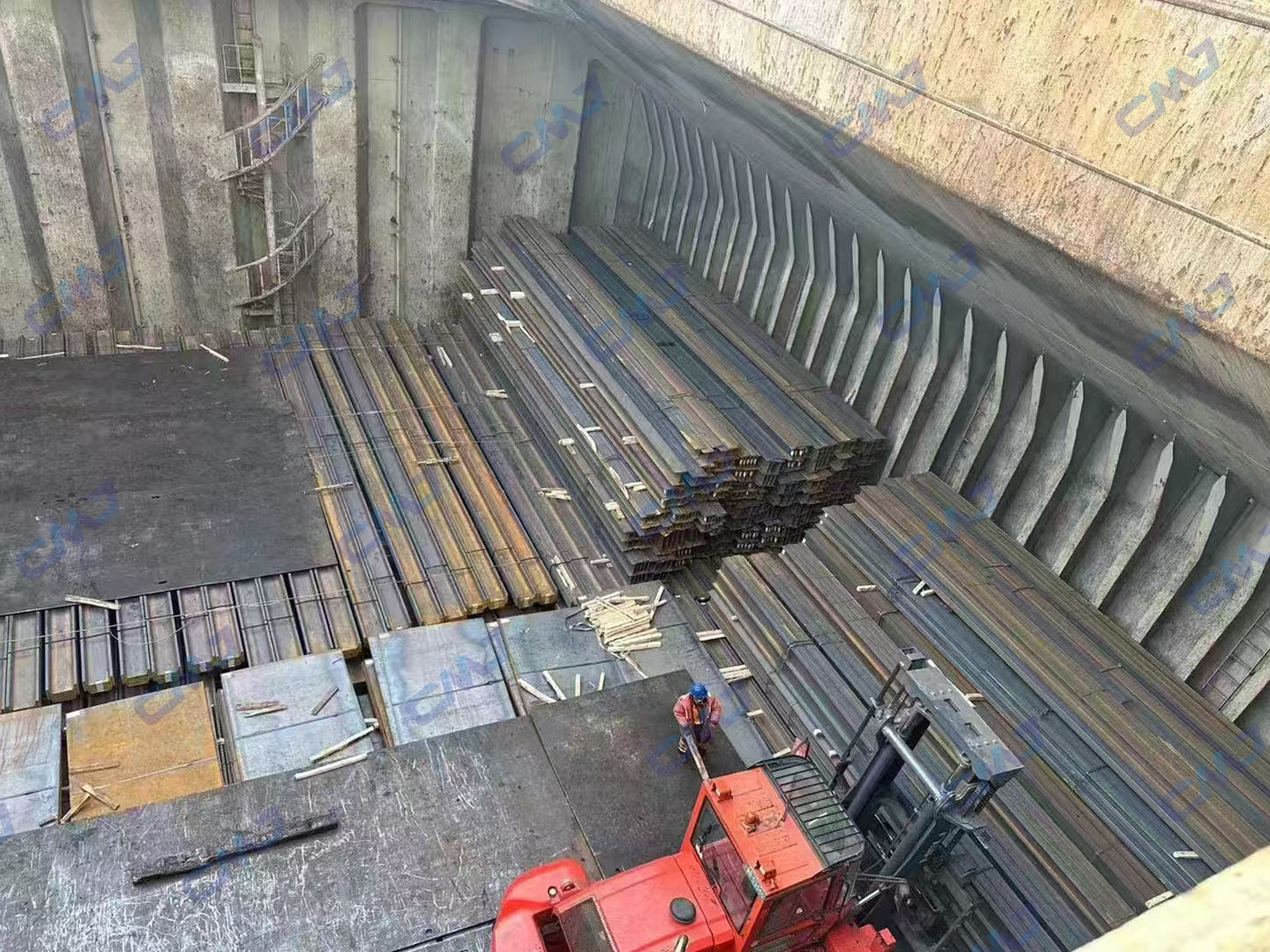 Carbon steel plates and structural profiles loaded into ship hold at Tianjin Portundefined