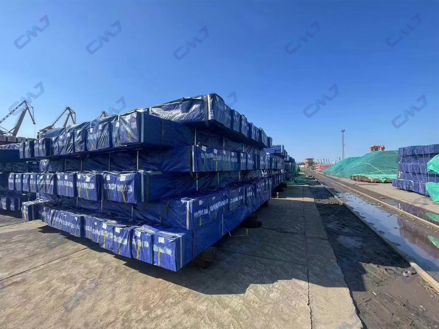 Bundled carbon steel profiles wrapped for export at Tianjin Port shipping yardundefined