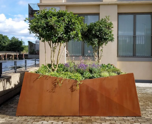 Garden landscaping featuring corten steel planter boxes and raised beds