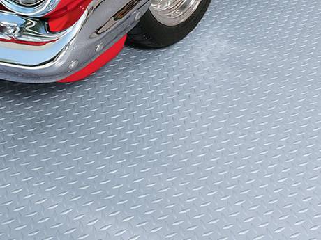 Checker plate steel flooring installed in garage for durability and slip resistance
