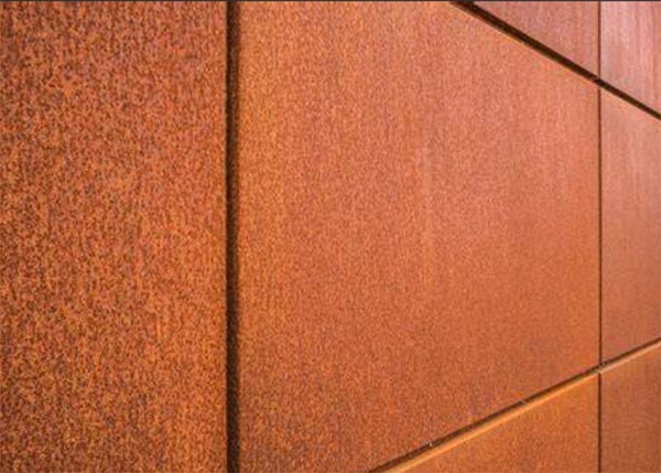 Close-up texture of weathered Corten steel showing rust patina