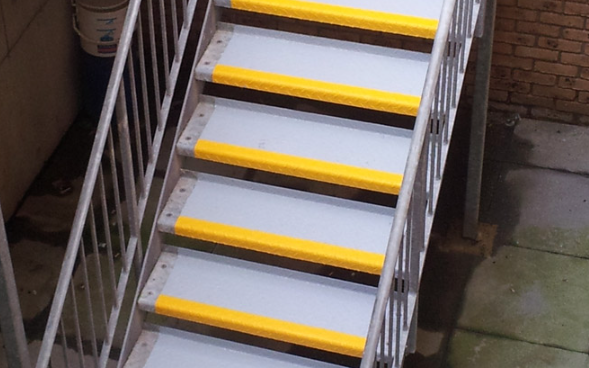 Industrial staircase built with steel checker plate treads and nosing for heavy duty use