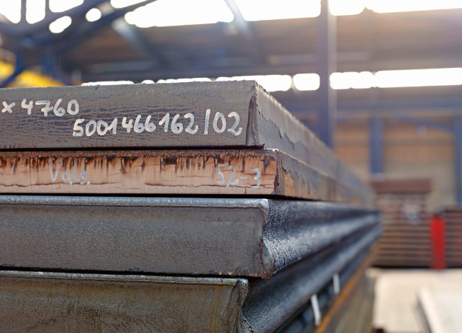 Extra thick steel plates stored in warehouse for heavy duty applications
