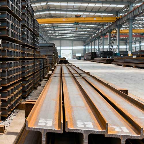 A large inventory of H beam steel sections neatly stacked in a stockyard showing various sizes