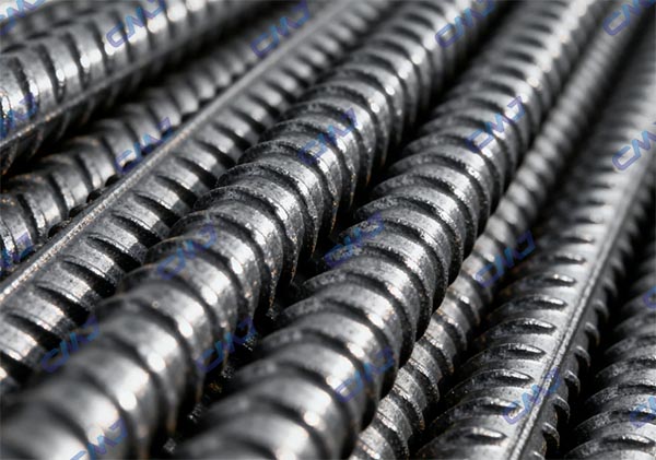 Close up of ASTM A615 rebar surface showing deformations and texture for concrete bonding